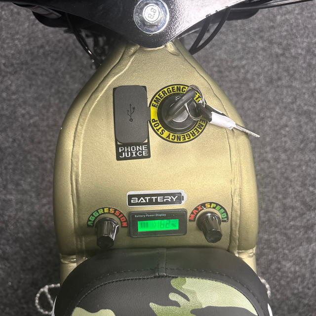 Close-up of a control panel with buttons and display on a vehicle, possibly a motorcycle or scooter.