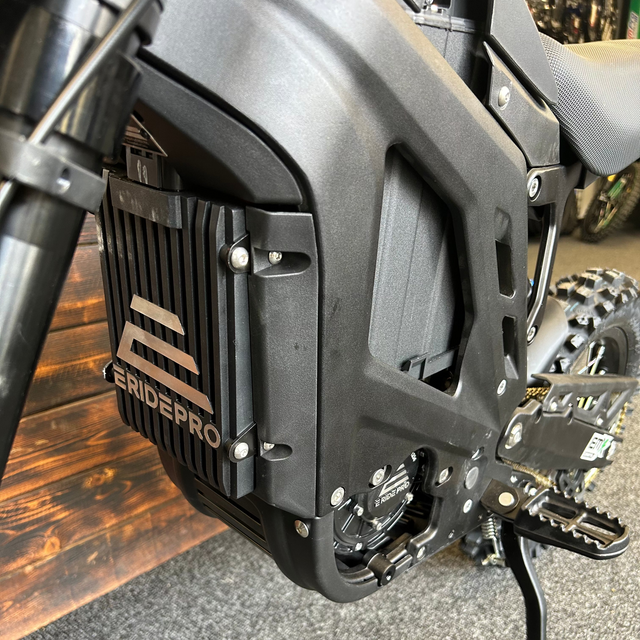 Close-up of a motorcycle engine with 'Endeavor Pro' branding on a wooden floor.