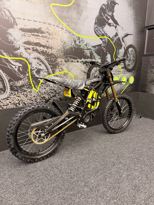 Motocross bike on display with a graphic of a rider in the background