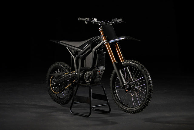 Electric bike on a stand against a black background