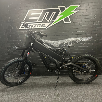 Black electric bike in front of a branded wall