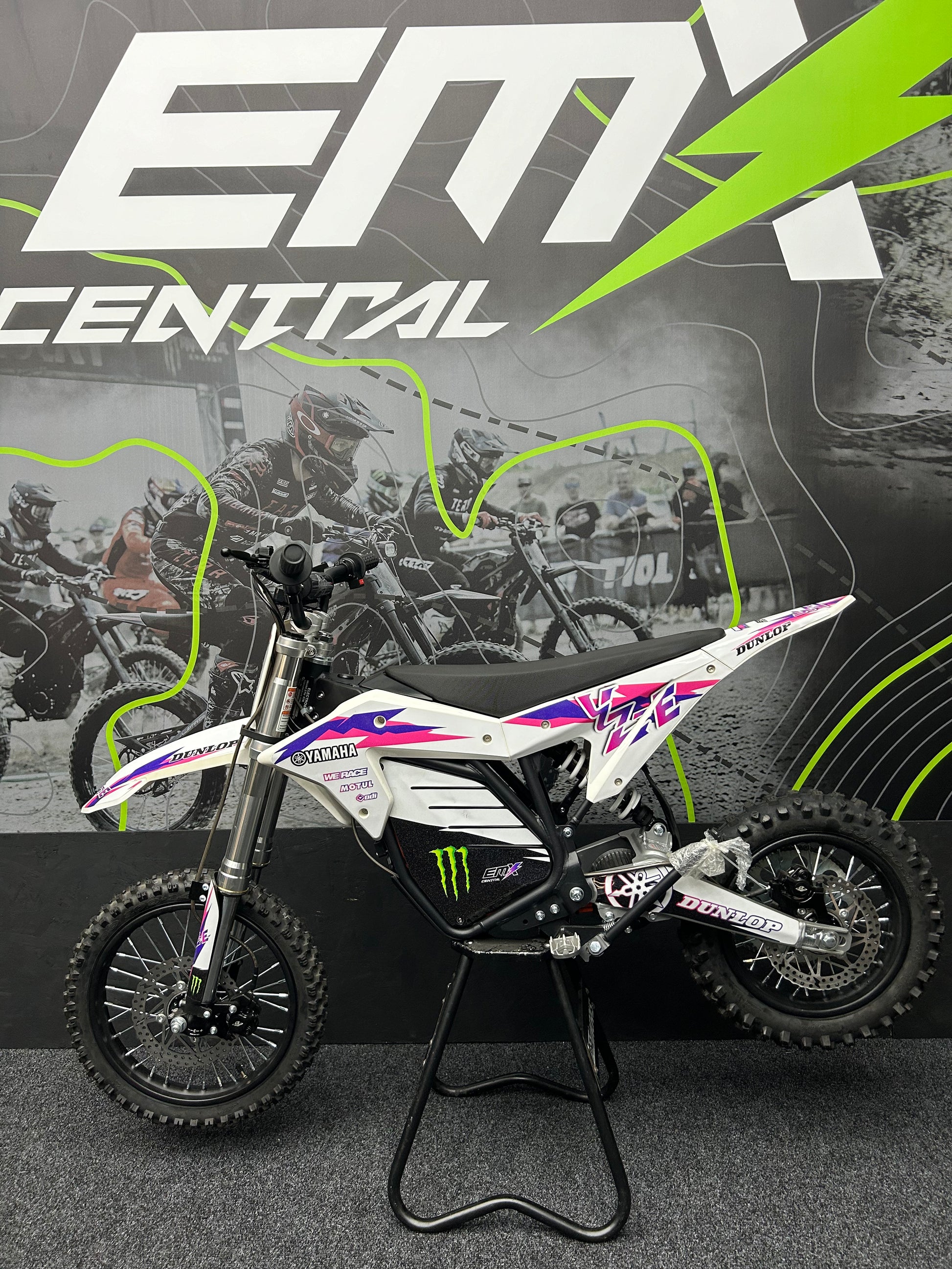 Motocross bike on a stand with 'EMX Central' branding in the background