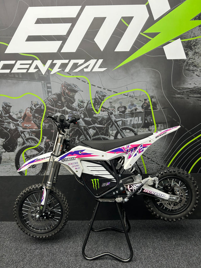 Motocross bike on a stand with 'EMX Central' branding in the background
