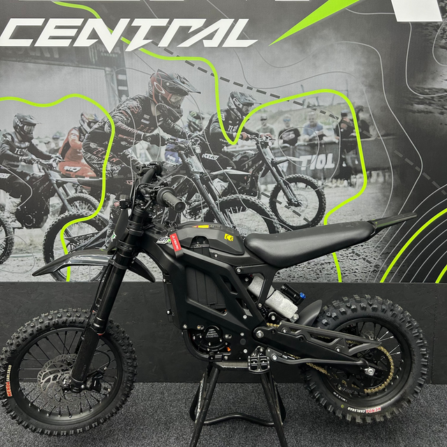 Black electric bike with 'EMX Central' branding in the background