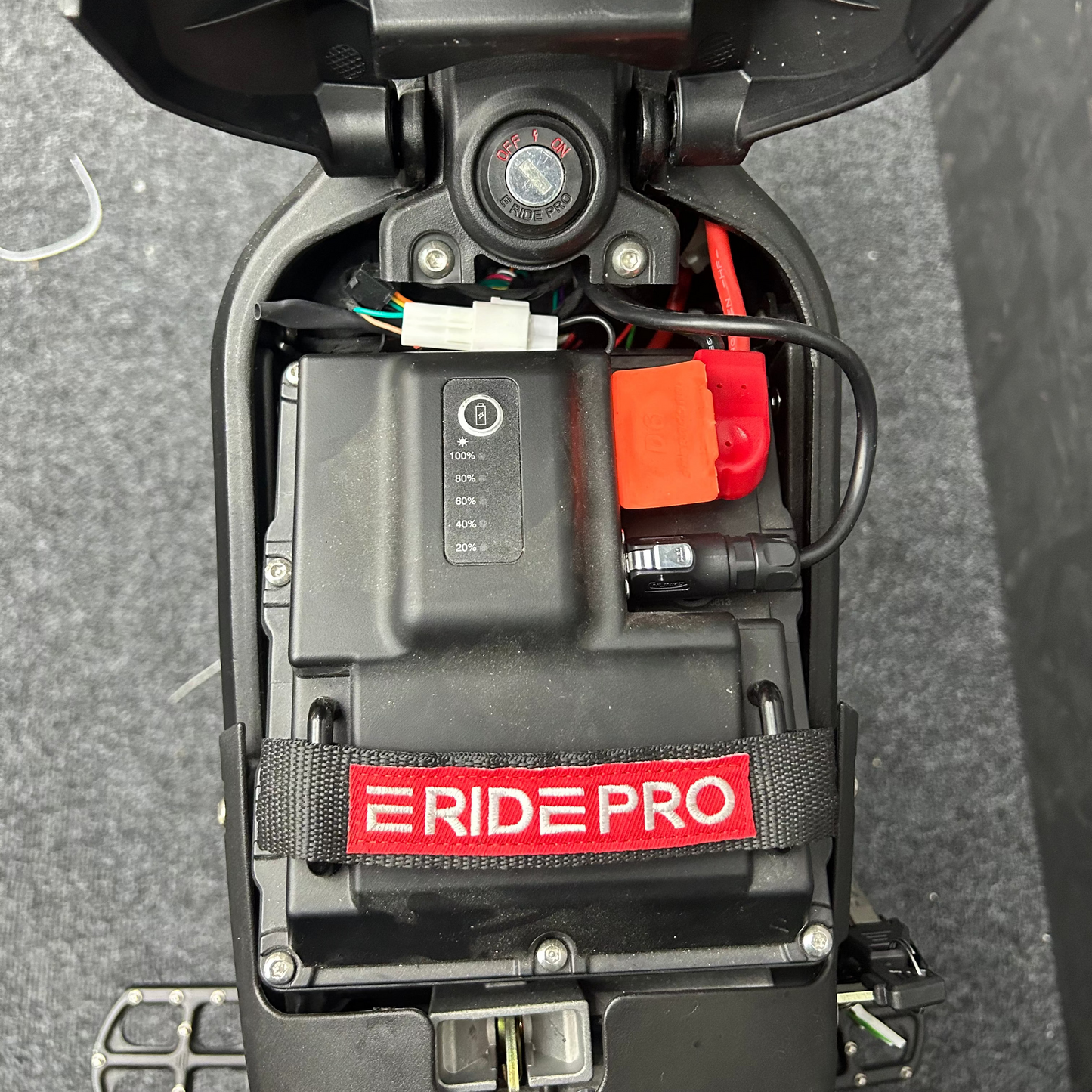 Close-up of a RidePro battery pack on a dark surface