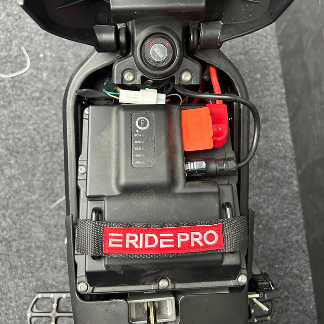 Close-up of a RidePro battery pack on a dark surface