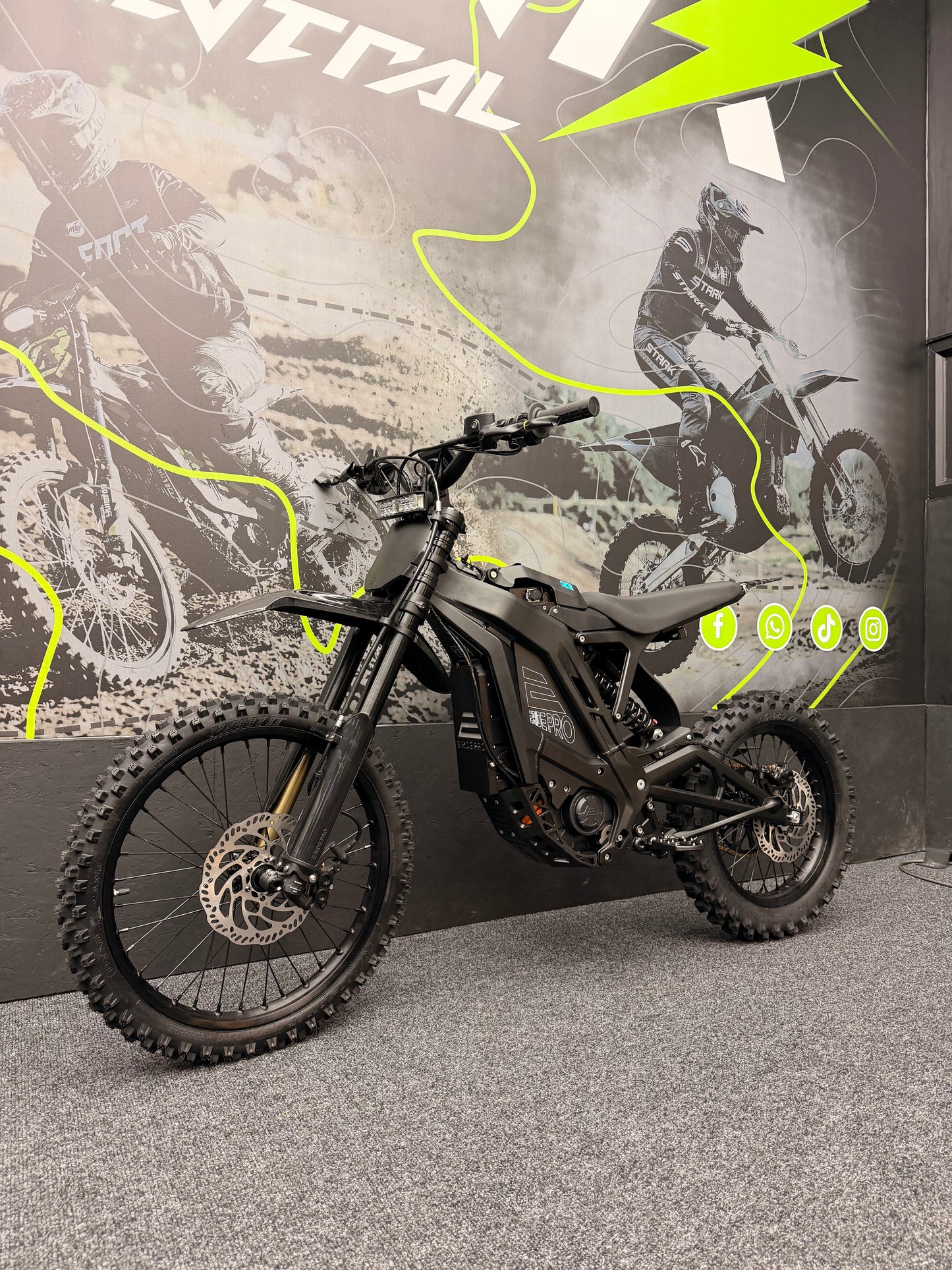 Motorcycle on display with promotional graphics in the background
