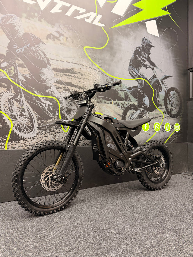 Motorcycle on display with promotional graphics in the background
