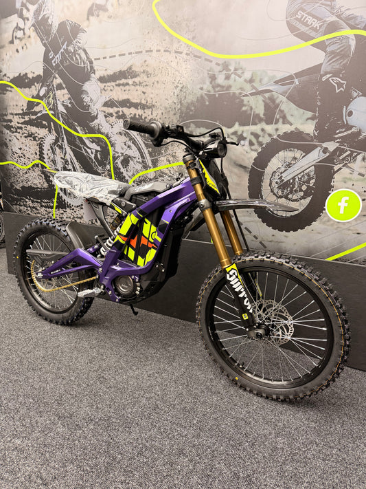 Purple dirt bike with visible branding on a textured surface