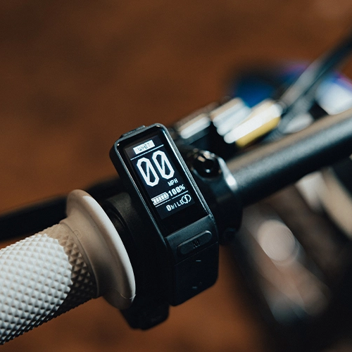 Digital display on a bicycle handlebar with blurred background