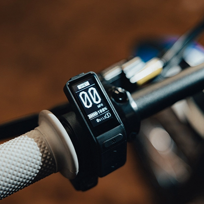Digital display on a bicycle handlebar with blurred background