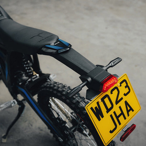 Bicycle with a yellow license plate on a concrete surface