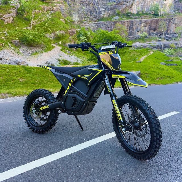 Black and yellow electric bike on a road with a scenic background