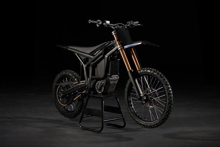 Electric bike on a stand against a black background