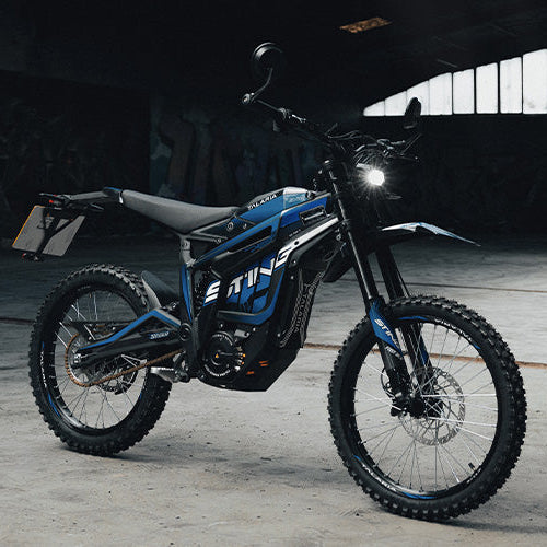 Blue electric bike with 'E-TWIN' branding on a dark background