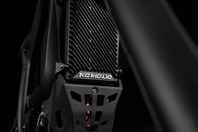 Close-up of a black metal frame with 'KOMODO' branding on a dark background