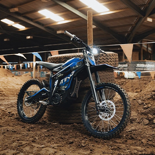 Blue dirt bike in an indoor dirt bike track